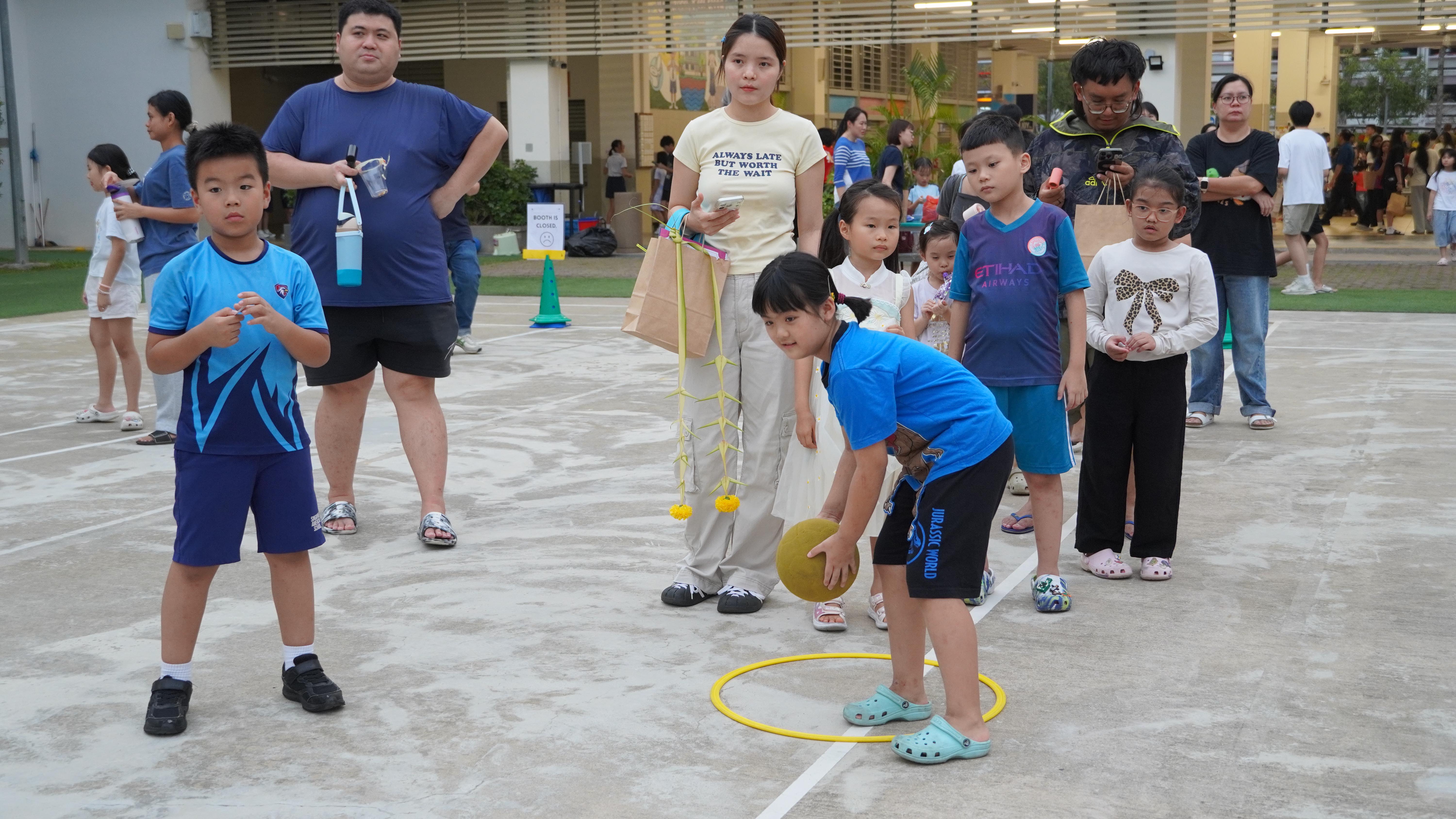 The excitement continues as participants line up for their turn, ready to put their aiming skills to the test.